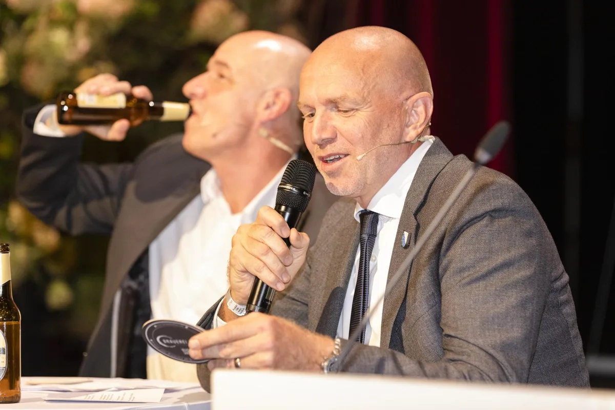 Zu schlucken gab es auch in der Fragerunde mit Moderator Christian Müller (mit Bierflasche) und Benno Scherrer (mit Bierdeckel)., Kritikerstimme zu Benno Scherrers Auftritt mit der Billy Bostitsch Bänd. , Zwei Regierungsräte mit dem Rücken zur Wand bei Scherrers Auftritt., 1983 zeigte sich der heutige Kantonsratspräsident Scherrer seinen Fans in Badehosen: das Plattencover der Billy Bostitsch Bänd., Für seinen Auftritt im Stadthofsaal hatte Benno Scherrer (rechts) den Krisenkommunikator Christian Müller zu Hilfe gezogen., Rund 300 Gäste verfolgten das lockere Abendprogramm im Stadthofsaal.  , Wäre Schildkröte nicht der passendere Pfadiname für den heute lahmenden Gepard alias Benno gewesen? , Regierungspräsidentin Jacqueline Fehr (SP) sticht in ihrer gelben Jacke aus der Menge.  , Der Pfadimusiker Gepard (rechts) bedankt sich bei einem richtigen Musiker.