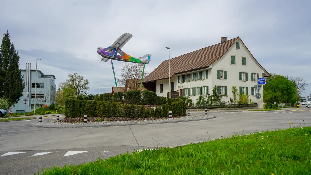 dsc01845 Der Flieger-Kreisel in Fehraltorf ist von Unbekannten farbig bemalt worden., Vor zwei Jahren – ebenfalls an Ostern – schmückten Unbekannte den Kreisel mit einem Osterei., Fast zehn Jahre lang stellte der Kreisel mit einem Ring aus Glasbausteinen ein Schwimmbad dar., Allerdings krachte viermal ein Auto in die Glassteine. 2016 wurde er nicht mehr aufgebaut., In der Folge platzierten Unbekannte einen Globus als Ersatz im Kreisel.
