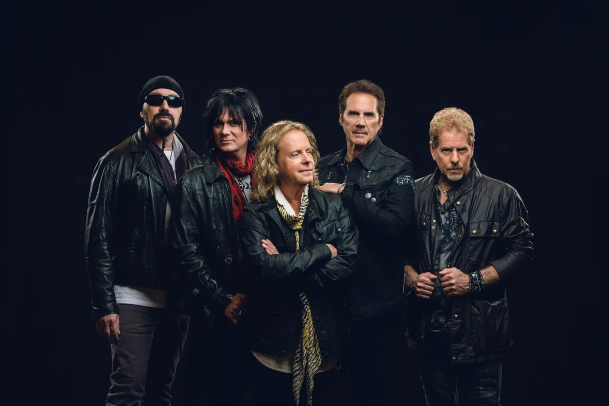 Fünf Musiker posieren für ein Foto der Band.