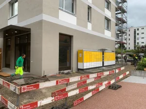 https-zueriost-ch-sites-default-files-media-2022-05-24-bild_von_ios_5-jpg Noch ist vor dem Gebäude, wo bald die neue Postfiliale eröffnet wird, eine Baustelle., Links die alte Post und rechts daneben die neue., Post-Pressesprecher Markus Werner an der neuen Beratungstheke., Hier sollen die Kunden bald ihre verpassten Pakete mittels Code abholen können., Die alte Post gleich neben dem neuen Gebäude beim Einkaufszentrum Zänti wird abgebrochen., Freitag, 24. Mai, ist der letzte Tag an dem die Filiale aus den 70er-Jahren geöffnet hat., Solche Schalter mit Sicherheitsscheiben wird es in der neuen Post nicht mehr geben.