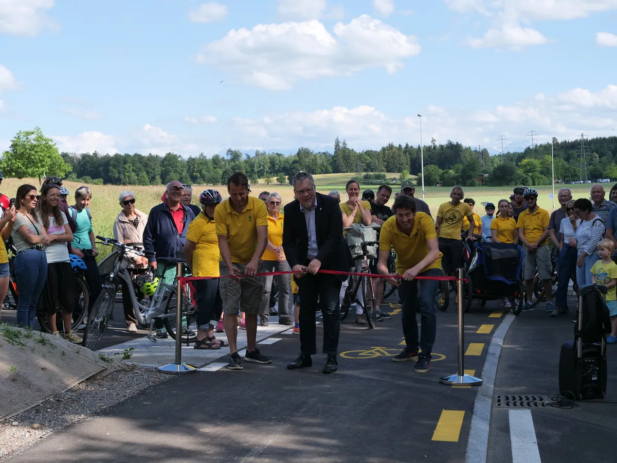 p1010830 Kurz vor dem Durchschnitt: Stadtrat Stefan Feldmann, flankiert von den beiden Co-Präsidenten des Dorfvereins Freudwil., Rund 100 Interessierte legten die Strecke von Uster nach Freudwil erstmals per Veloweg zurück., Der Dorfverein Freudwil kombinierte die Eröffnung des Velowegs kurzerhand mit dem Dorffest., Stadtrat Stefan Feldmann blickte in seiner Rede auf die lange Entstehung des Velowegs zurück.