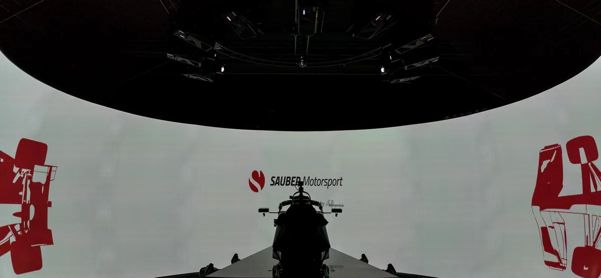 Ein Cockpit und eine riesige gekrümmte Leinwand: Dieser Simulator steht in Hinwil., Erst seit dieser Saison kann Sauber den Simulator aber für die Weiterentwicklung nutzen., Valtteri Bottas zieht die Handschuhe an und macht sich für eine Simulatorsession bereit., Die Anlage an der Wildbachstrasse ist unterdessen täglich in Betrieb., Bottas während der Fahrt: Die Rückmeldung der Piloten ist ein zentrales Element.