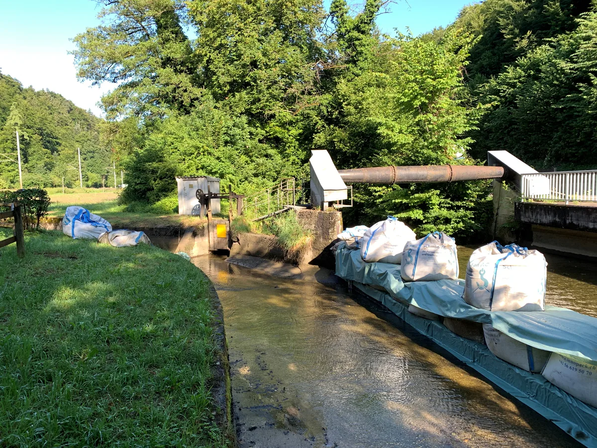 Wo sich der Aabach und der Kanal scheiden, werden zu Beginn der Aabach-Ferien Sandsäcke aufgetürmt, die alles Wasser ins Bachbett leiten. 