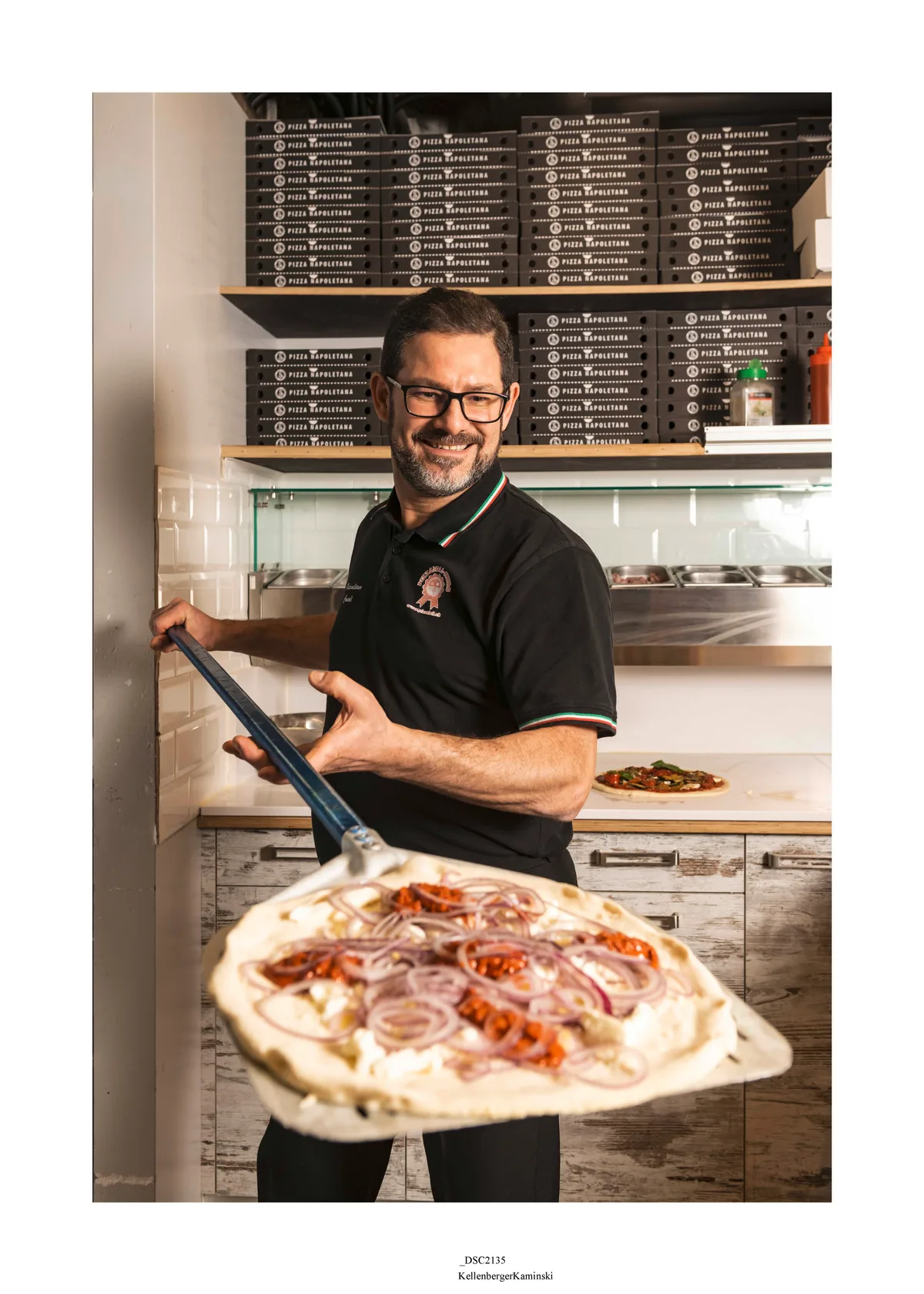 Massimo Consoli hält ein Pizza-Blech.