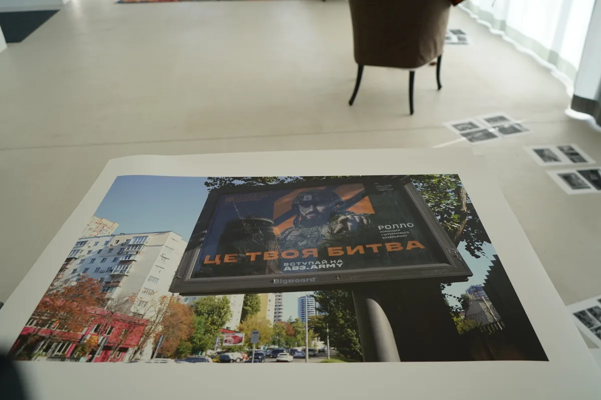 Urs und Gian Walder halten Plakate der Ausstellung hoch.