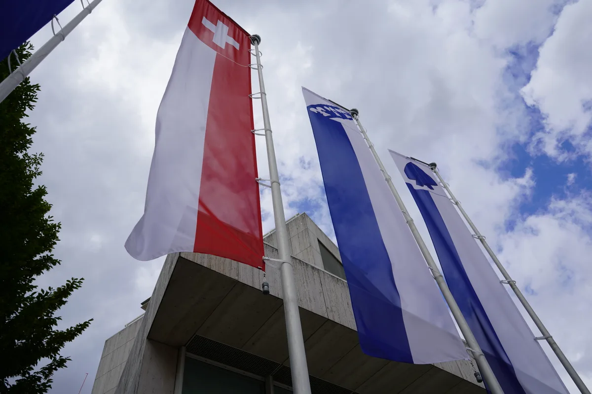 Mehrere Flaggen wehen vor dem Stadthaus in Illnau-Effretikon im Wind.