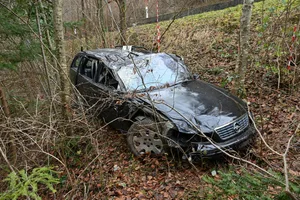 Ein zerbeultes Auto zwischen Bäumen. Ein zerbeultes Auto zwischen Bäumen.