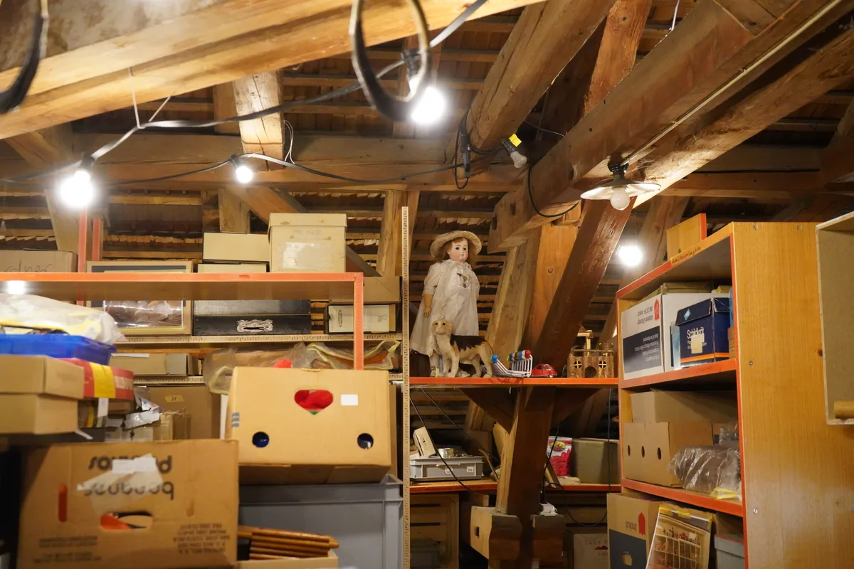 Kisten und Spielzeuge auf einem Dachboden.