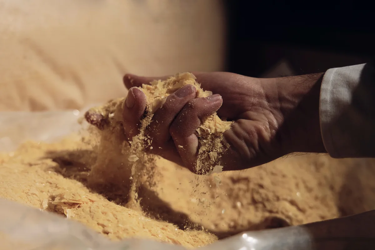 Eine Hand wühlt in Flocken.