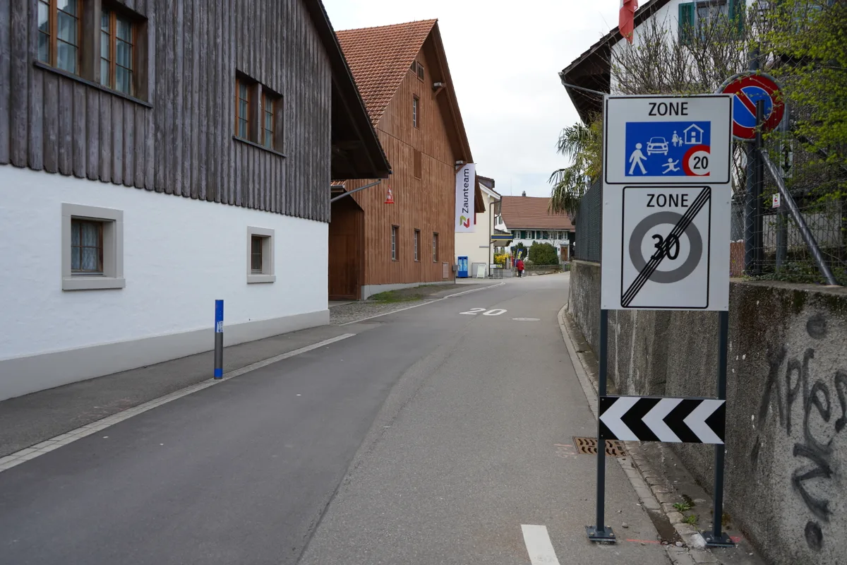 Ein Dorfzentrum mit Häuser und Tempo 20 Tafeln. Es sind Strassen im Volketswiler Dorfteil Gutenswil.