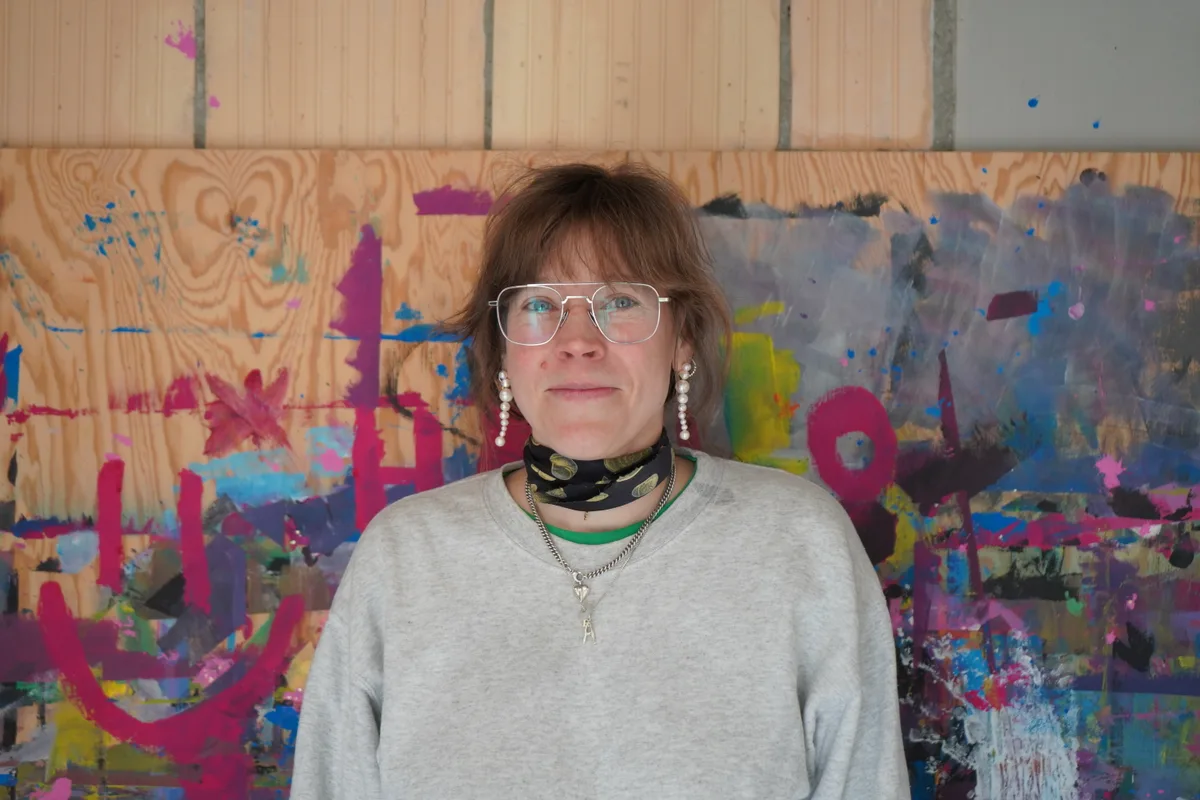 Enid Kohler vor der Malwand.