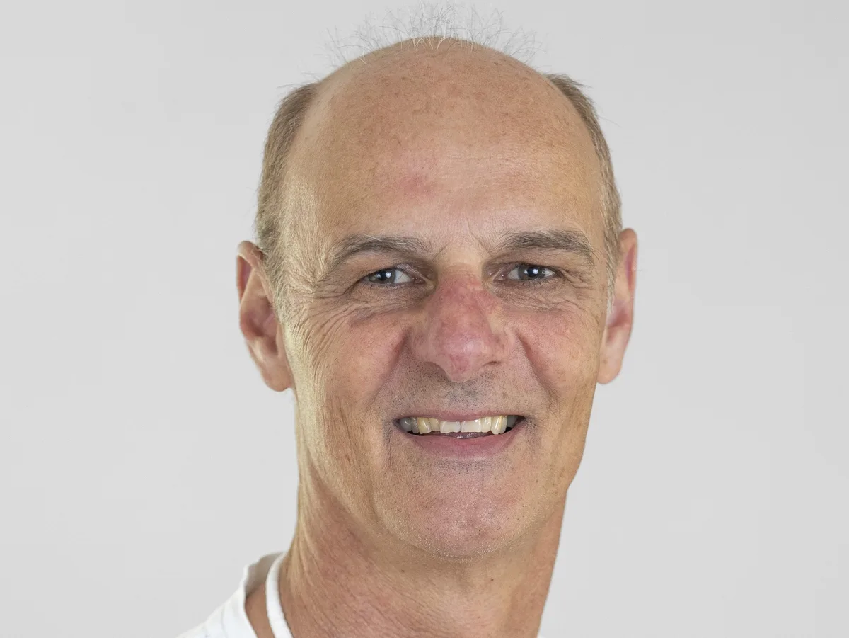 Porträtbild eines Mannes mit Glatze.