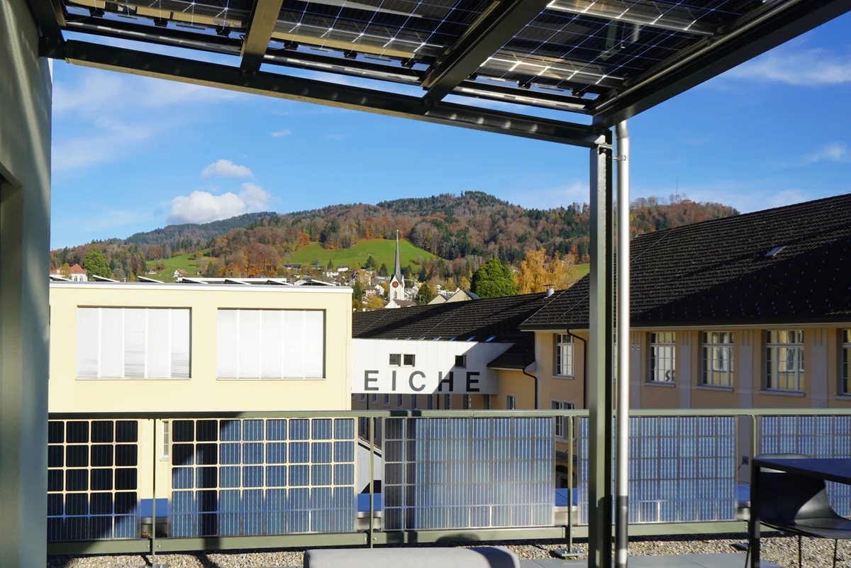 Die Terrasse am Sitz der EW Wald AG. Man sieht ein Geländer und eine Überdachung, beides aus Solarpanels.