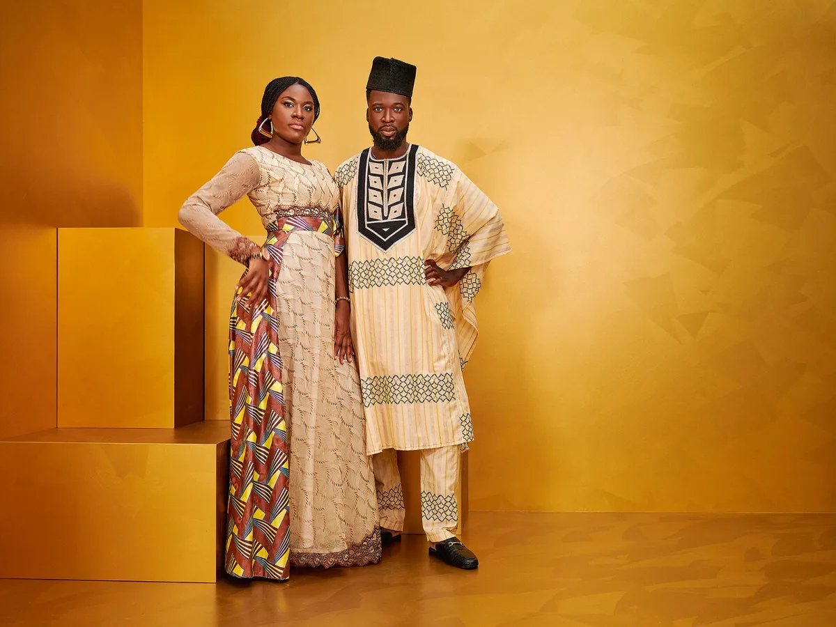 Traditionelle Gewänder für den grossen Auftritt: Allein der Stoff für ein solches Kleid kann einen Monatslohn kosten. Westafrikanische Menschen in farbenfrohen Damastkleidern. Die Stoffe werden unter anderem in der Weberei Russikon hergestellt.