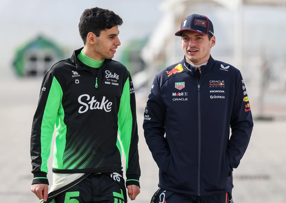 Gabriel Bortoleto of Brazil and Stake F1 Team Kick Sauber and Max Verstappen of the Netherlands and Oracle Red Bull Racing talk as they walk in the Paddock during day one of F1 Testing at Bahrain International Circuit on February 26, 2025 in Bahrain, Bahrain.