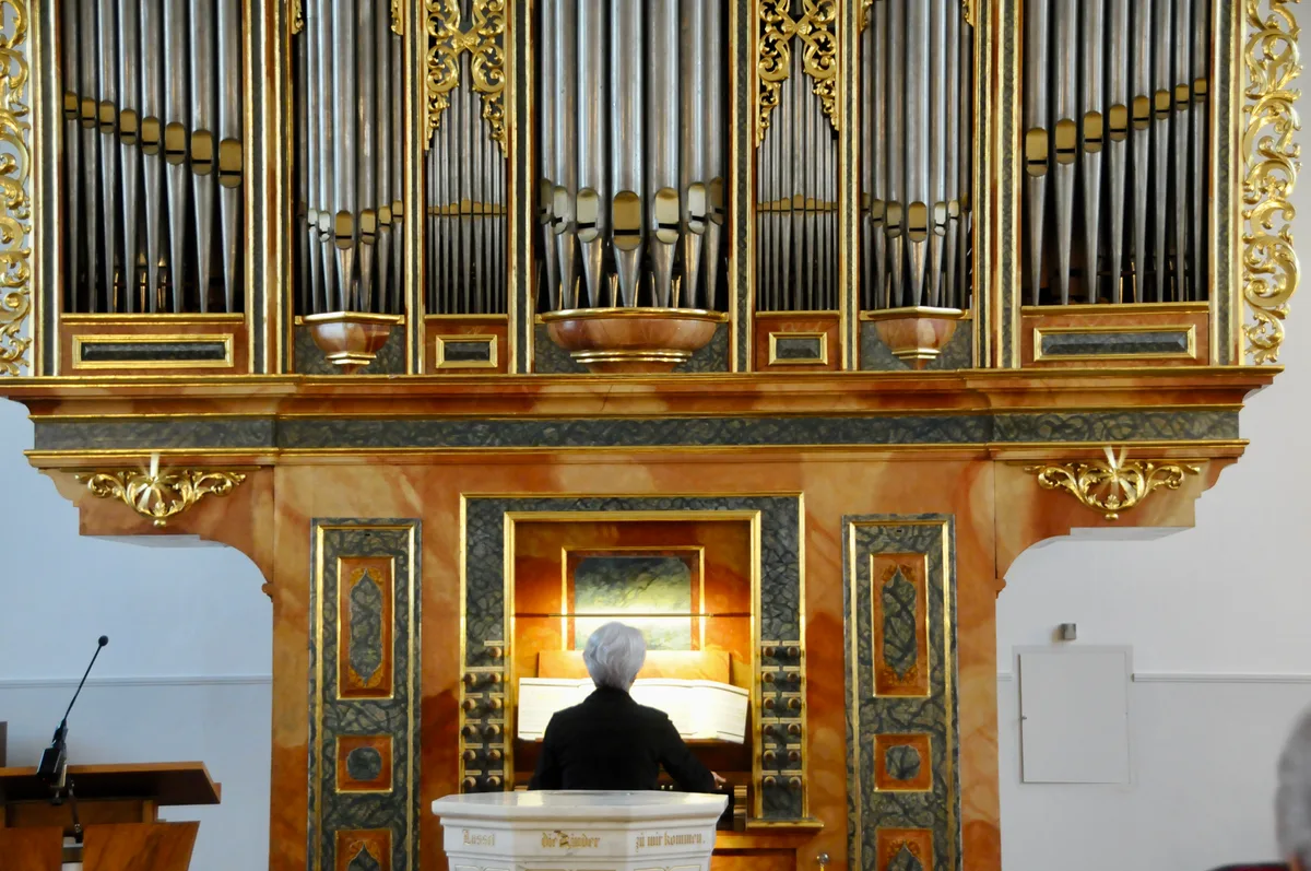 Man sieht eine Frau an der Orgel.