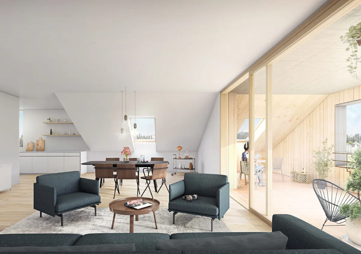 Ein Blick über ein Sofa in einem Wohnraum, rechts ist ein Balkon durch eine grosse Fensterfront sichtbar.