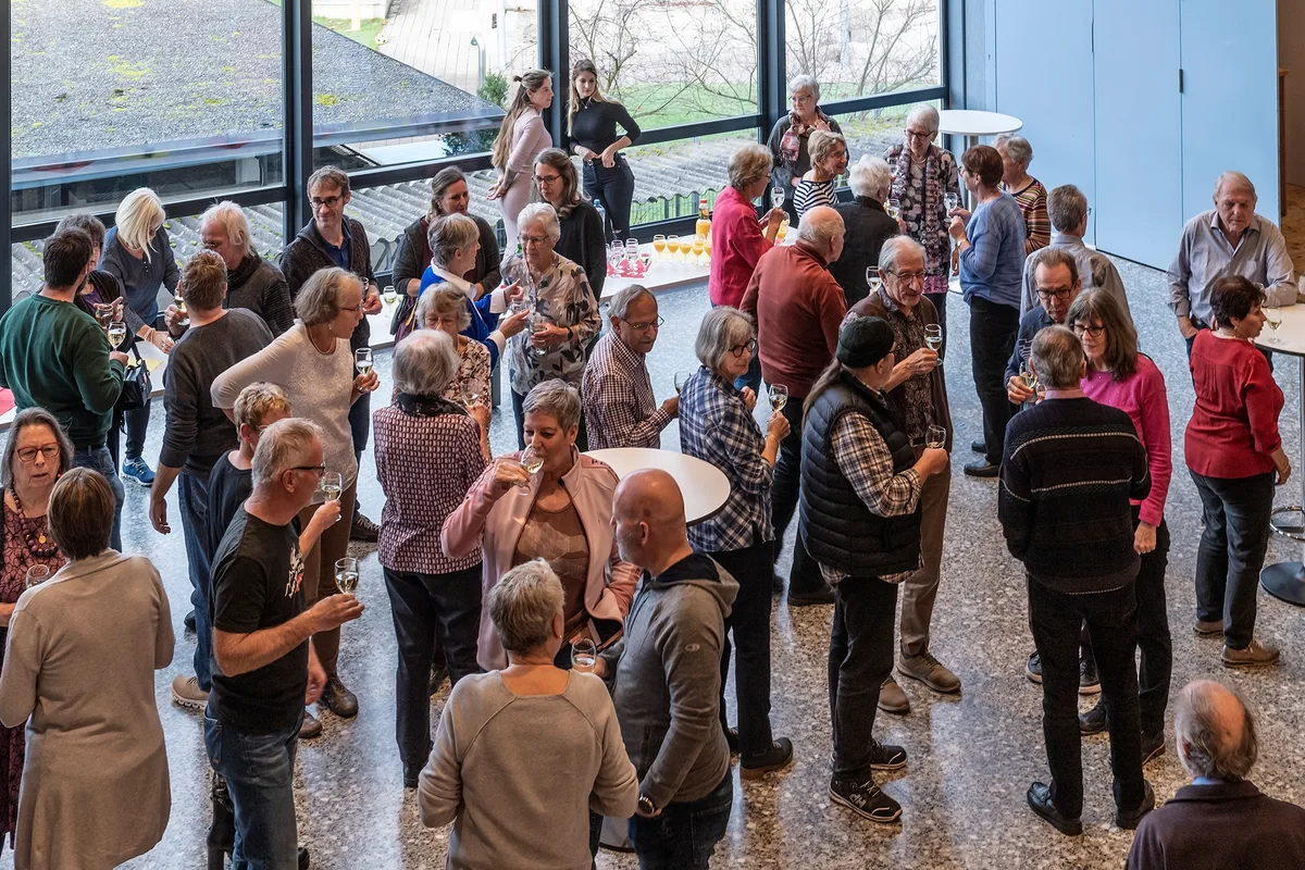 Zuerst gab es einen Apéro. Man sieht Menschen beim Apéro.