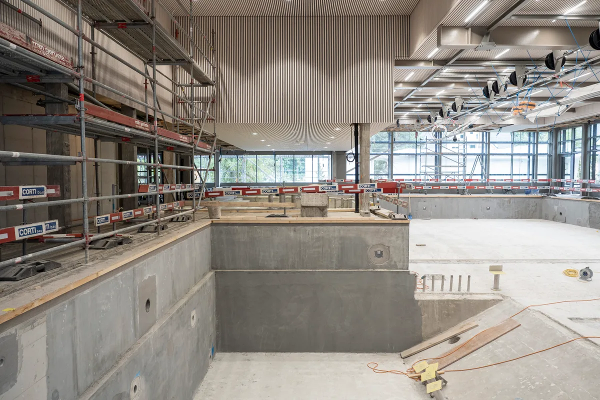 Blick auf die Baustelle: Man sieht die Halle mit Schwimmbecken.