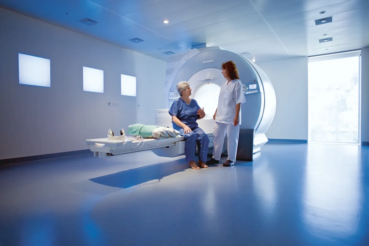 25043817-4 eine medizinisch technische Radiologie-Assistentin (MTRA) instruiert eine Patientin vor einer MRI-Untersuchung