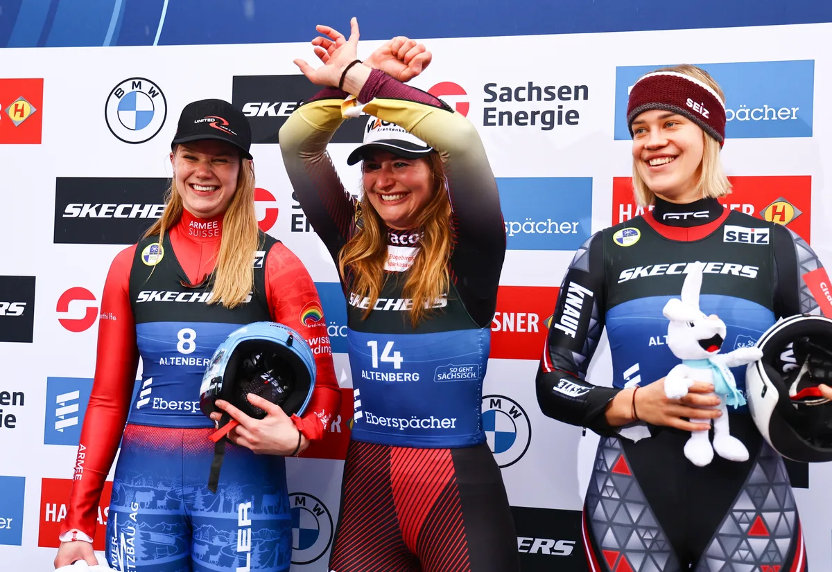 epa11105984 (L-R) Second placed Natalie Maag of Switzerland, first placed Julia Taubitz of Germany, and Elina Leva Vitola of Latvia celebrate on the podium for the Sprint Women's Singles Final at the FIL Luge World Championships in Altenberg, Germany, 26 January 2024.  EPA/FILIP SINGER