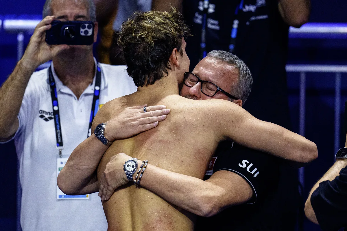 Noe Ponti of Switzerland celebrates with his third Gold medal after winning in a New World Record time in the Men's 100m Butterfly Final with his coach Massimo Meloni during the World Aquatics Swimming Championships (25m) in Budapest, Hungary, Saturday, Dec. 14, 2024. (KEYSTONE/Patrick B. Kraemer)