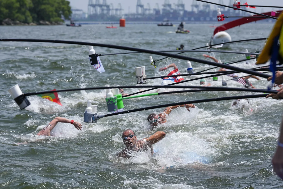Competitors stop for drinks during the men's 10km open water swim at the world swimming championships in Singapore, Wednesday, July 16, 2025. (AP Photo/Vincent Thian)
Singapore Swimming Worlds