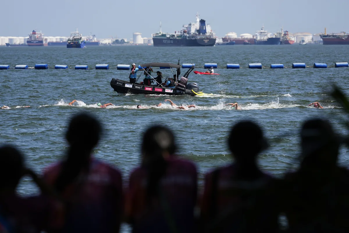 Spectators watch as swimmers compete in the men's 10km open water swim at the world swimming championships in Singapore, Wednesday, July 16, 2025. (AP Photo/Vincent Thian)
Singapore Swimming Worlds