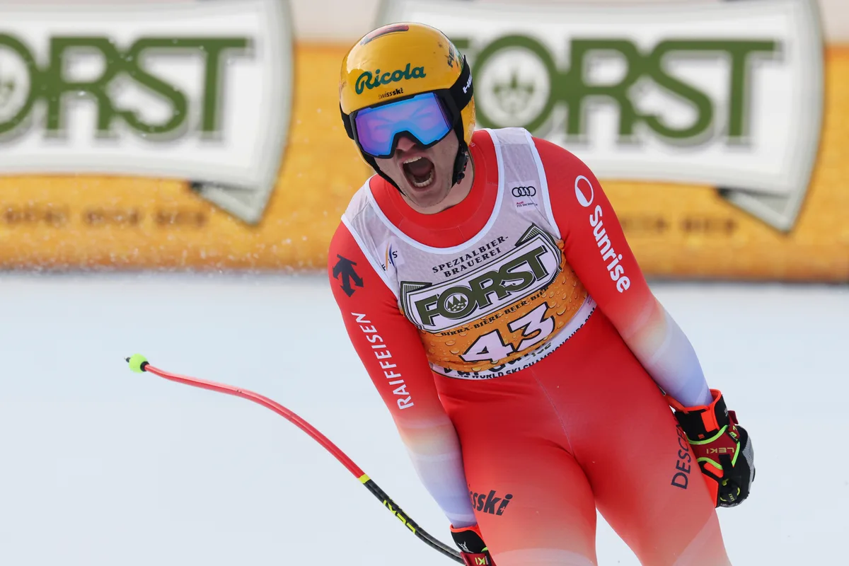 Switzerland's Alessio Miggiano celebrates at the finish area of an alpine ski, men's World Cup downhill, in Val Gardena, Italy, Saturday, Dec. 20, 2025. (AP Photo/Alessandro Trovati)