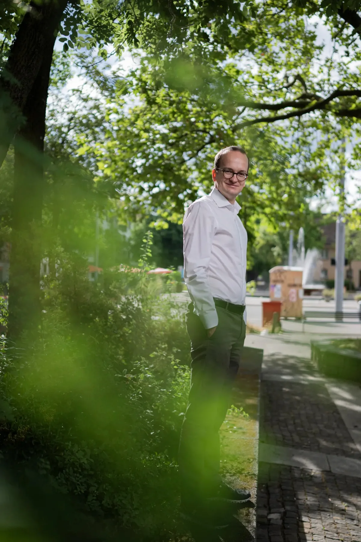 Der grüne Baudirektor Martin Neukom nimmt für die neuen Deponien im Kanton Zürich auch Baumfällungen in Kauf. Mann mit weissem Hemd posiert für Porträt.